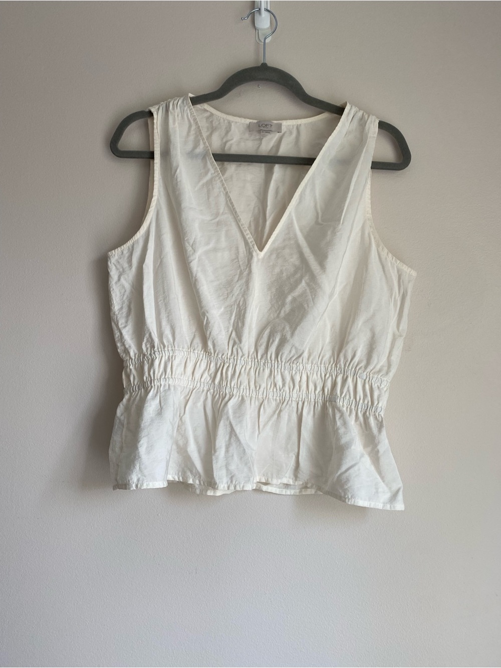 Loft cream-colored smocked peplum tank top size medium